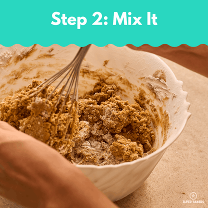 Hands mixing batter in a white bowl for Date Cake Baking Mix showing the step to mix ingredients.